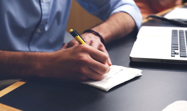 A man writing down some notes